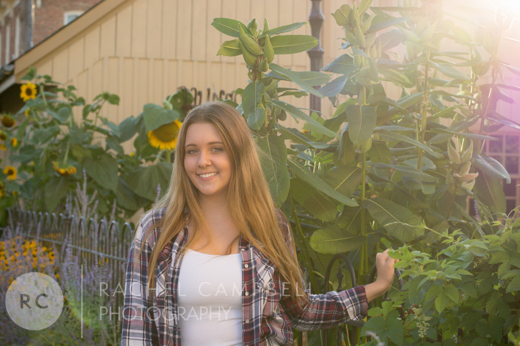 Senior portrait of a young woman at sunset standing among flowers in Solon Ohio