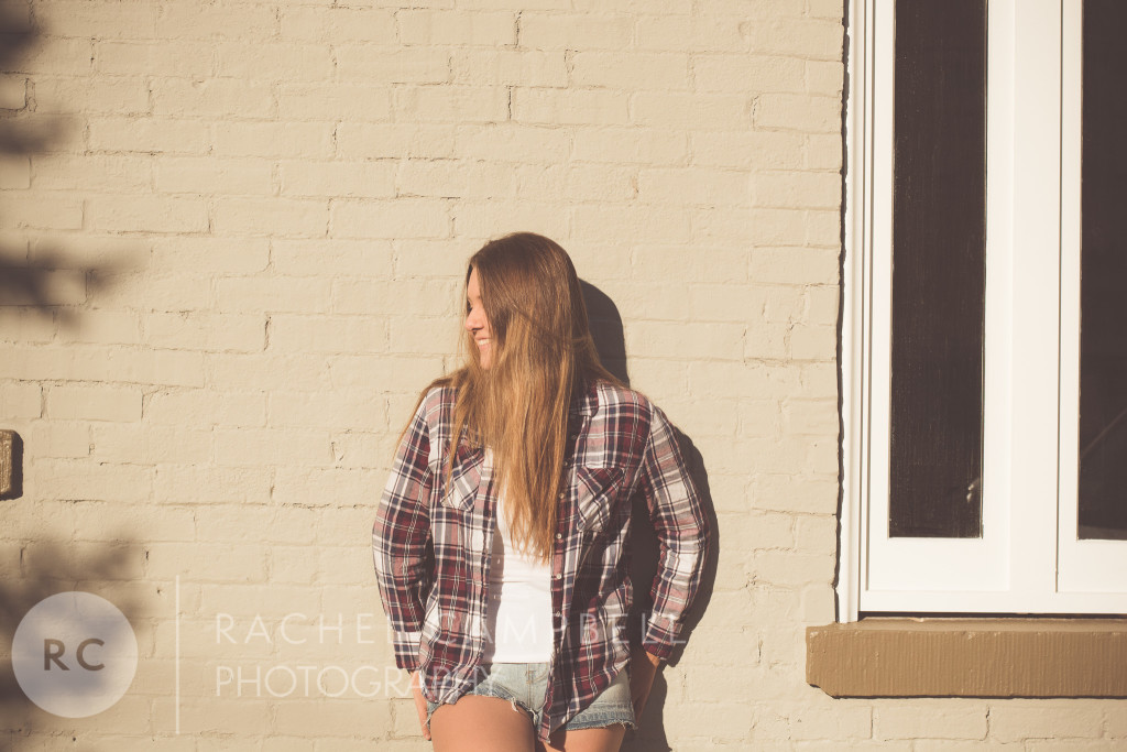 Senior portrait of a young woman leaning against a wall in Solon Ohio