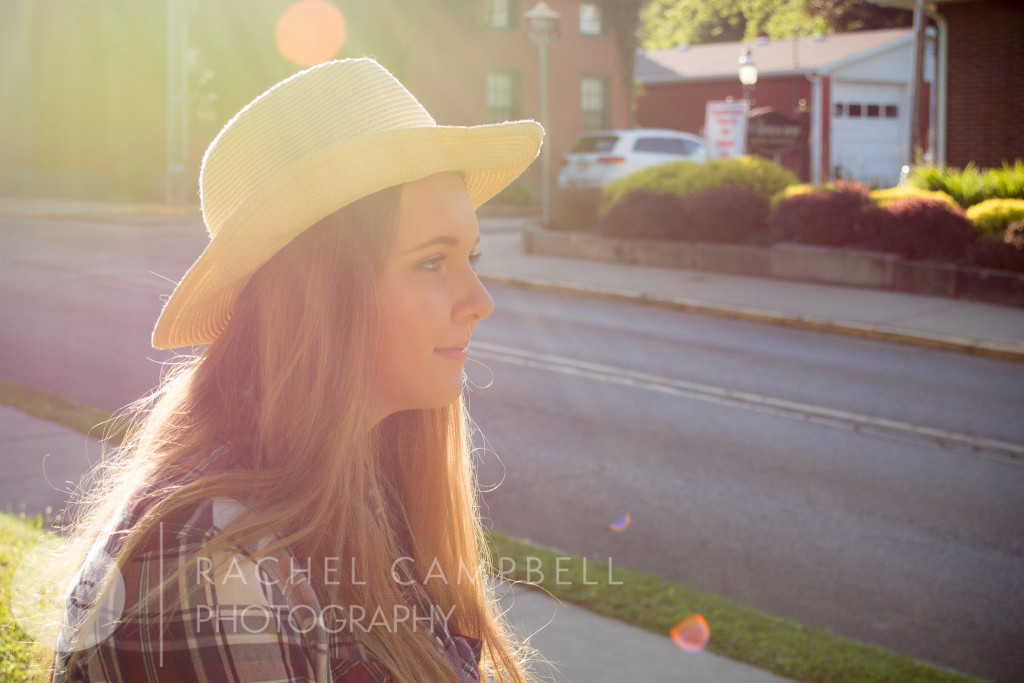 Senior portrait of a young woman at sunset wearing a cowboy hat in Solon Ohio