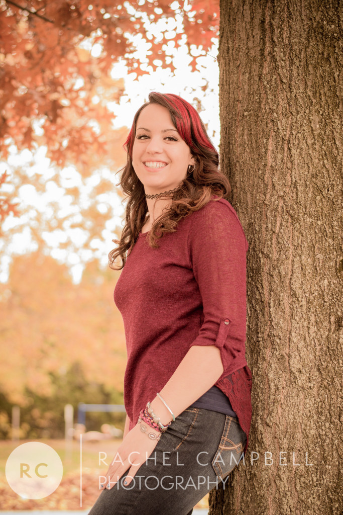 Senior portrait of a young woman leaning against a tree in Solon Ohio