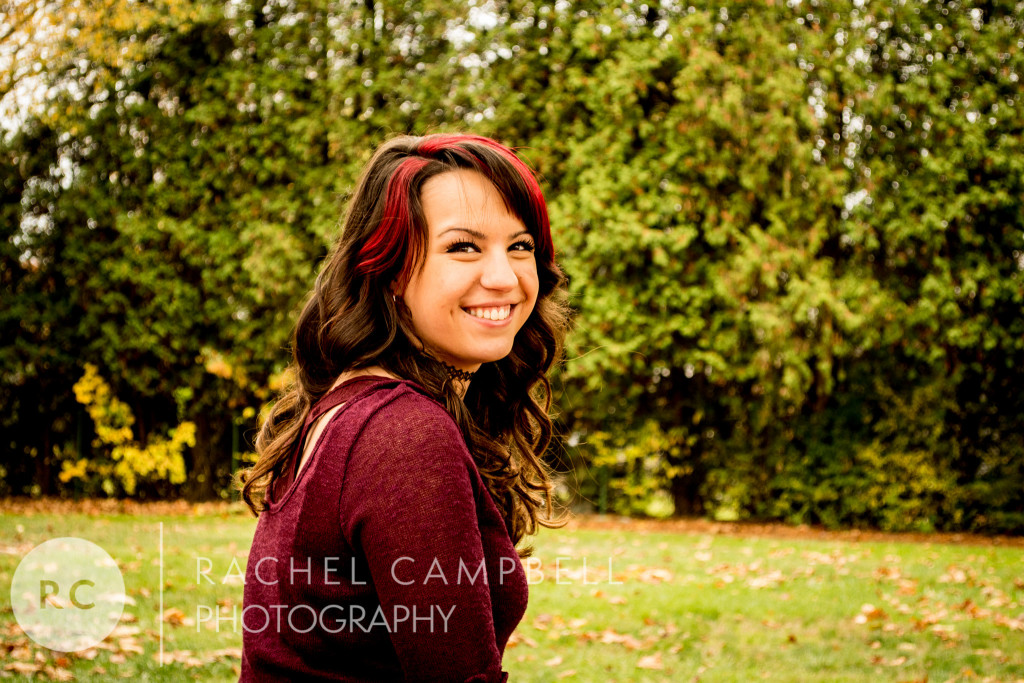 Senior portrait of a young woman sitting in a park in Solon Ohio
