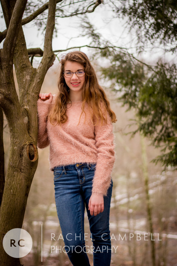 Senior portrait of a young woman leaning against a tree in Solon Ohio