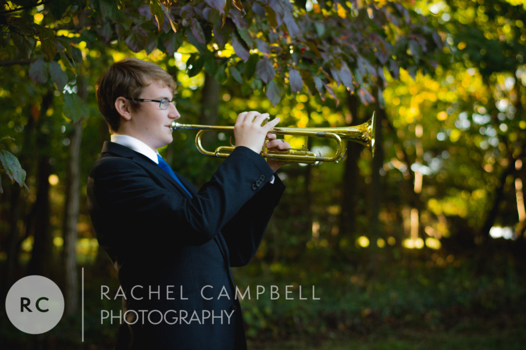 Senior portrait of a young man playing his trumpet in Solon Ohio