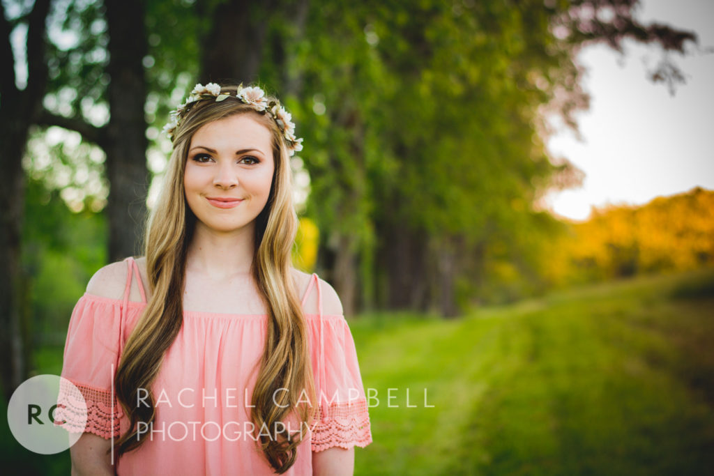 Senior picture of a young woman standing in a field at sunset in Solon Ohio