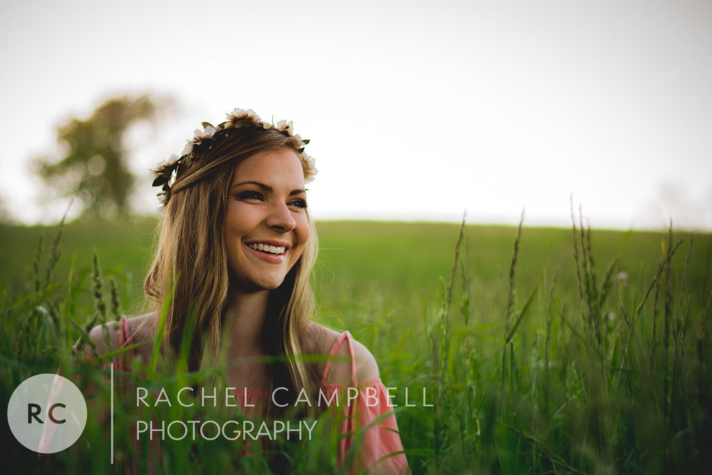 Senior portrait of a young woman sitting in a field in Solon Ohio