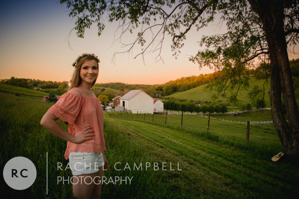 Senior portrait of a young woman standing in a field at sunset in Solon Ohio