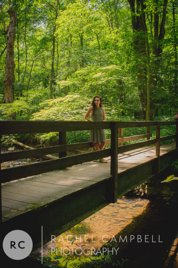 Senior portrait of a young lady standing on a bridge in the woods Solon Ohio