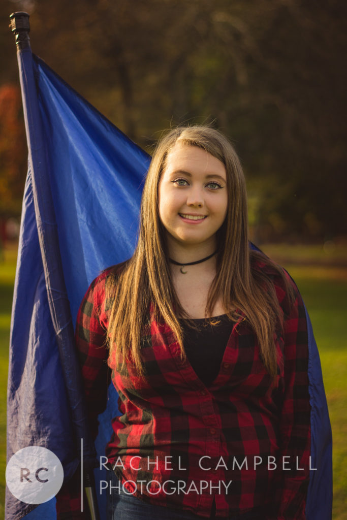 Senior portrait of a young woman wrapped in a flag in Solon Ohio