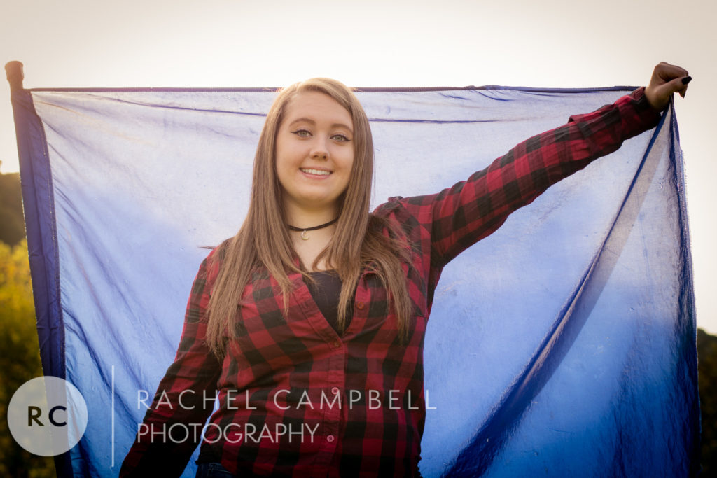 Senior picture of a young woman holding a flag in Solon Ohio